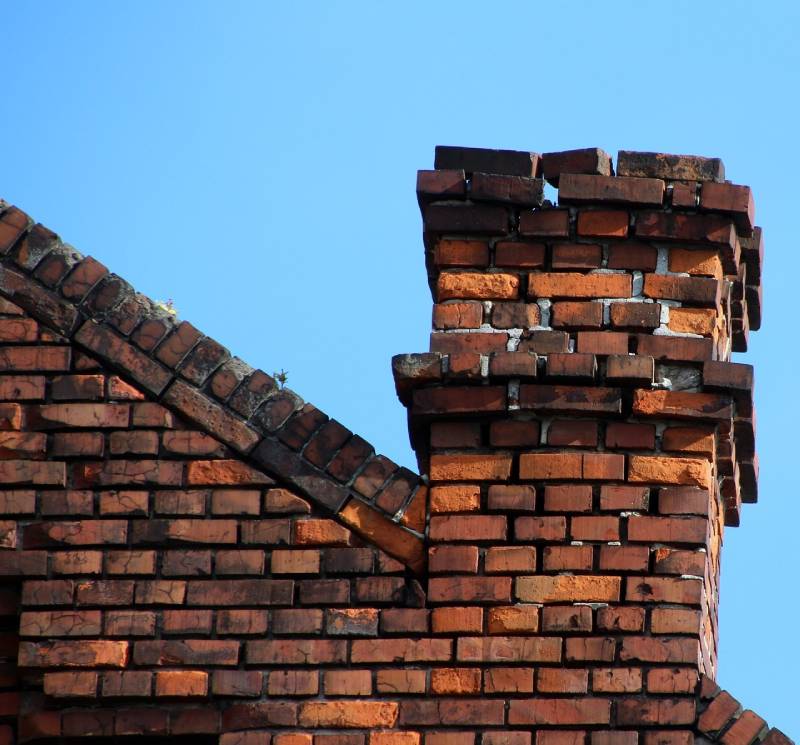 Damaged chimney on an Middle River home showing cracks and missing mortar